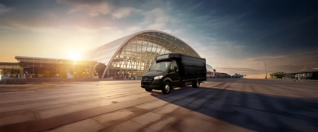 Black passenger shuttle van in front of an airport