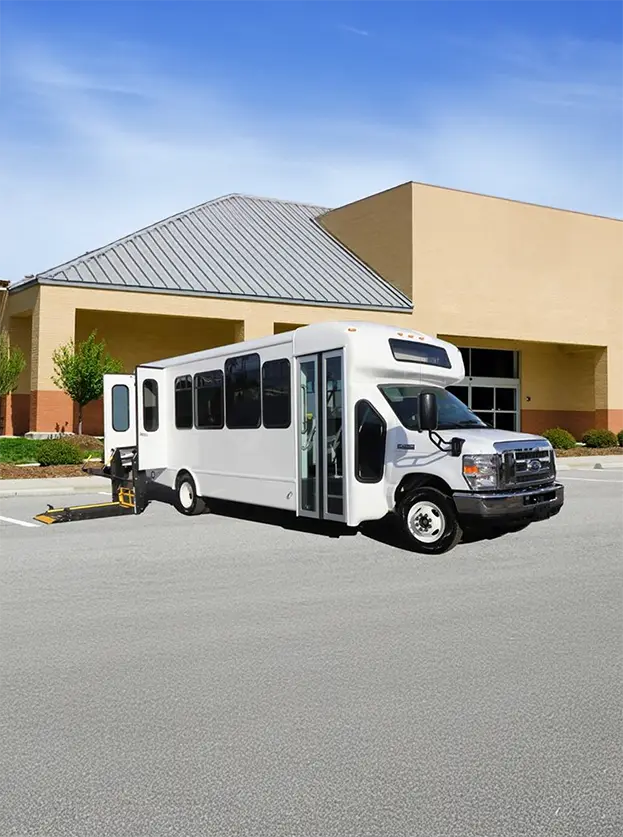 handicap shutter van in white parked in a lot with a beige building in the background