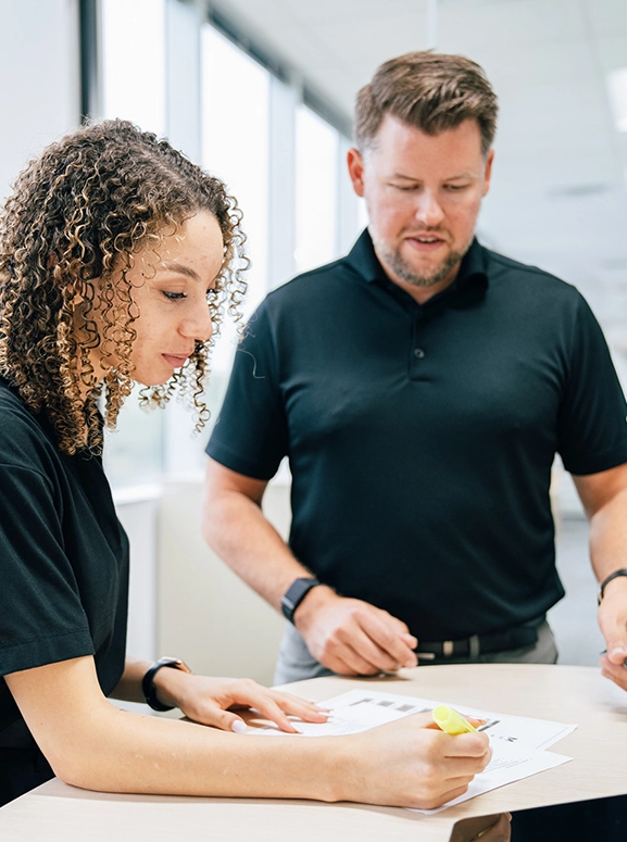 woman and man looking at forms for renting a vehicle in Texas